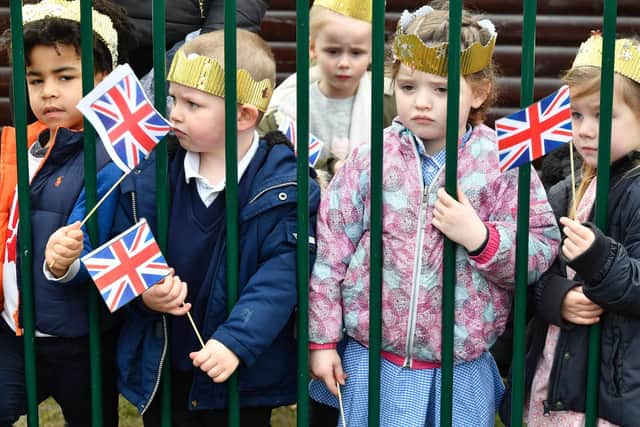 School children wait for the Duchess of Cambridge to arrive for a visit to Pegasus Primary School in Oxford