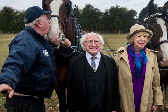 James Coffee from Roscommon Ploughing kisses his horse as President Michael D Higgins with his wife Sabina Coyne pose for a photo during the Irish 2018 National Ploughing Championship in Tullamore, Co. Offaly, Ireland