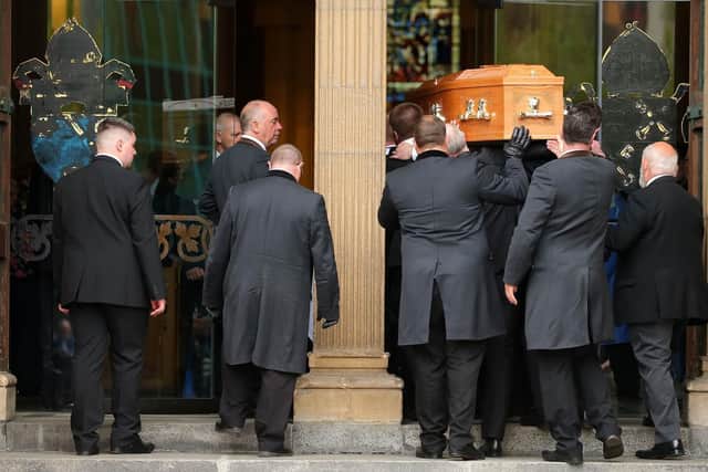 Lyra McKee's coffin is carried inside.