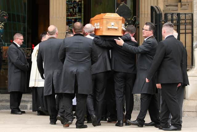 Lyra McKee's coffin is carried inside.