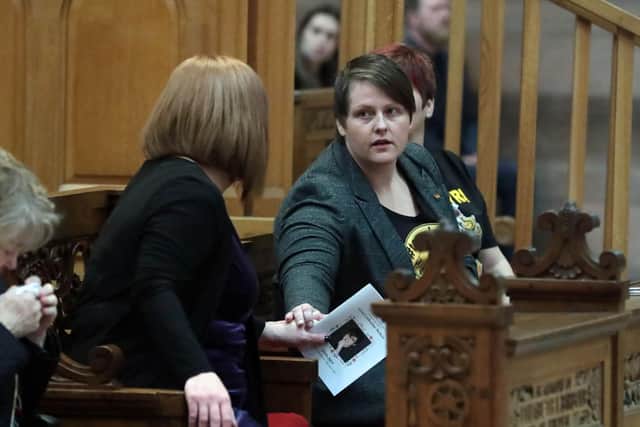 Lyra's partner, Sara (right) shakes hands with Lyra's sister, Nicola, before the funeral.