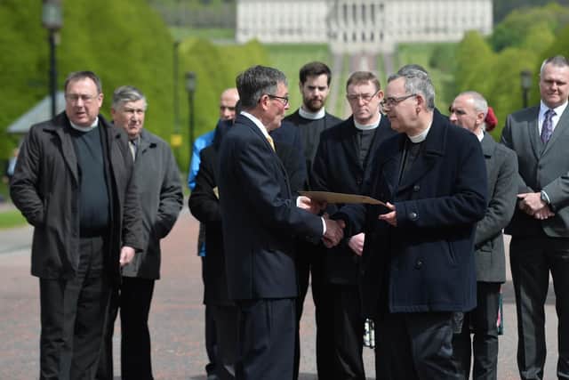Presbyterian Moderator Gordon Dane hands a letter of protest to David Seaton (chairman of the Belfast Marathon) during a protest rally at Stormont.