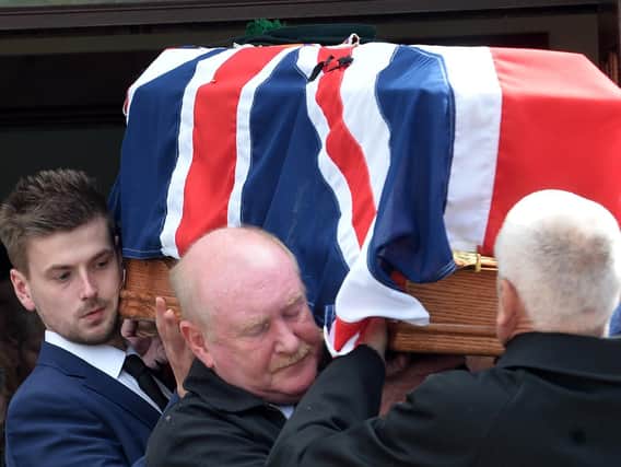 Mr. Frazer's coffin is carried from the Five Mile Hill Pentecostal Church in Bessbrook on Monday.