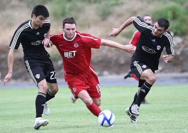 Kevin Braniff battling between two Qarabag rivals at Shamrock Park in the 2010 Europa League. Pic by Pacemaker.
