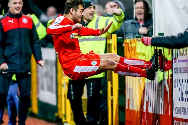 McDaid celebrates a goal during his time with Cliftonville