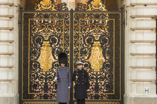 A Royal Navy officer (right) stands alongside a guardsman, as sailors from the Royal Navy perform the Changing of the Guard ceremony at Buckingham Palace, London, for the first time in its 357-year history. PRESS ASSOCIATION Photo. Picture date: Sunday November 26, 2017. Eighty-six sailors from 45 Royal Navy ships and establishments have spent a month learning the intricate routines, and have now been deemed ready to perform the ceremony for real. The ceremony - performed since the restoration of King Charles II in 1660 - is traditionally performed by one of the five Foot Guards Regiments from the army's Household Division. See PA story ROYAL Sailors. Photo credit should read: Dominic Lipinski/PA Wire