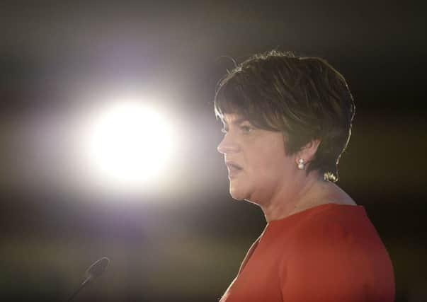 DUP leader Arlene Foster, pictured speaking at the party's annual conference at the La Mon hotel, criticised Simon Coveney during an interview with RTE