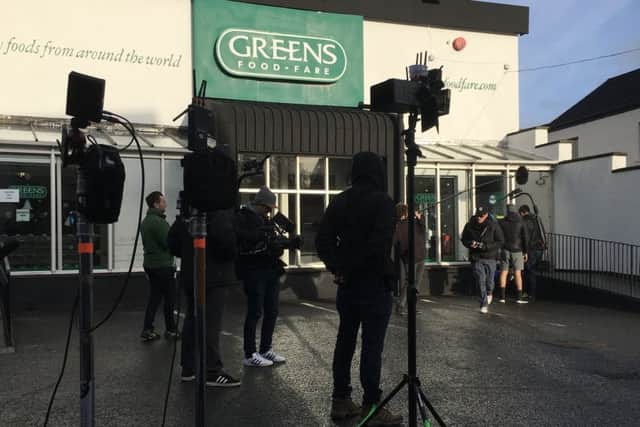 The crew setting up for a scene outside Greens Food Fare.