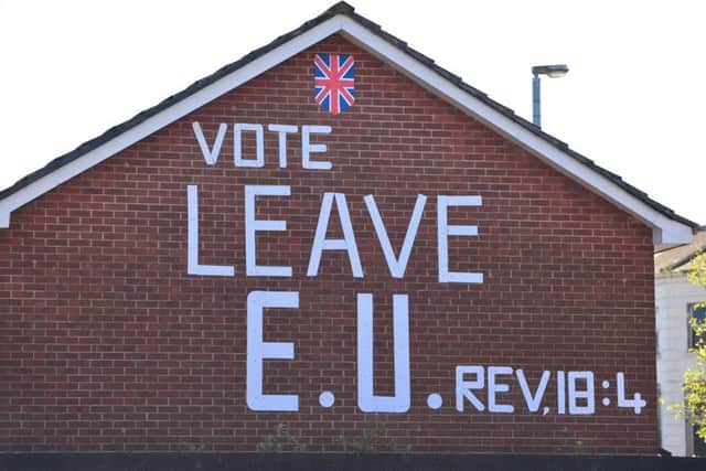 A pro-Brexit slogan in loyalist Tiger's Bay, Belfast. Stephen Farry has said unionists and nationalists are taking seemingly mutually-exclusive approaches to Brexit.