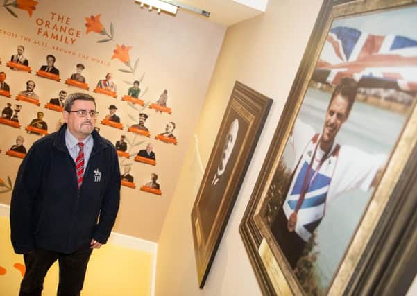 Museum of Orange Heritage curator, Jonathan Mattison, at the newly installed wall of fame recognising the achievements of Orangemen and women in various fields