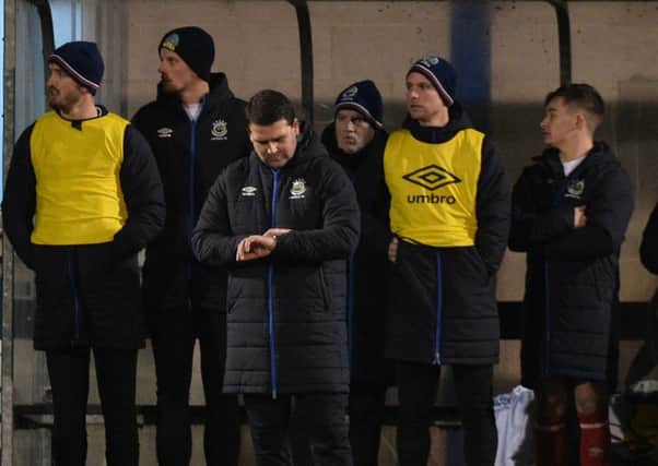 Linfield manager David Healy keeps an eye on his watch against Glenavon last Friday night