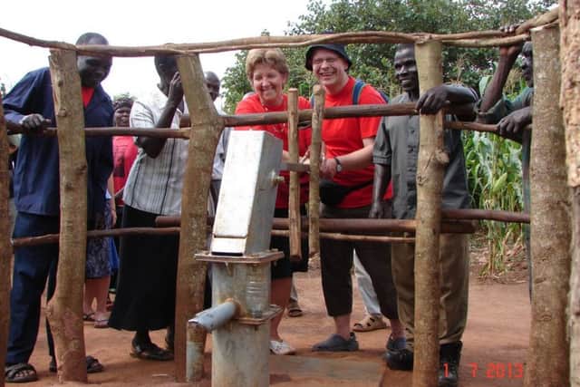 Dr Dickie Barr with his wife Janice at the borehole built with the help of Charlene's Project in Uganda