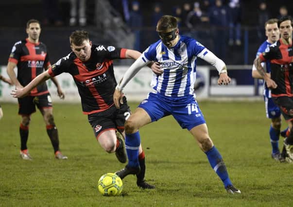 Coleraine's Brad Lyons in action with Crusaders Billy Joe Burns. Â©INPHO/Stephen Hamilton