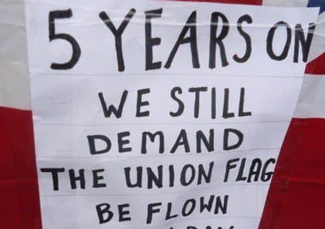 Five years after the Union Flag is taken down from Belfast City Hall, protestors send in this pic and the following press release from William Dickson which they say was read out on Dec 2: 
"On this our 5th Anniversary of the Union Flag Protests, we wish to pay tribute to those who faithfully came along each week in all weathers and at times had to face attacks by those who took offense at our presence.
Will our protests continue? Many have been asking that question. The answer to that is yes. The weekly flag protest is a protest by individuals and not under any organization, but the general view is that the protests will continue as a reminder to all of that infamous action by Belfast City Council in taking down the flag of our country.
We have had our problems with what we view as political policing, but we wish to thank the police on duty at the front of Belfast City Hall for their weekly presence, thus ensuring our right to hold a peaceful protest."