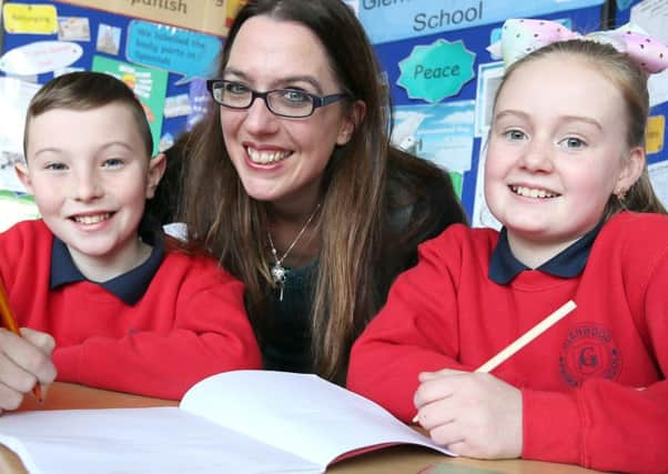 Carter Loughlin and Madison Mckeown from Glenwood PS, help Myra Zepf, Northern Ireland's first children's writing fellow, launch the Commonwealth Class Short Story Competition