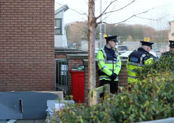 Members of the Garda at the scene in Barnwell Drive, Dublin, where a member of the Irish Garda and a man were shot