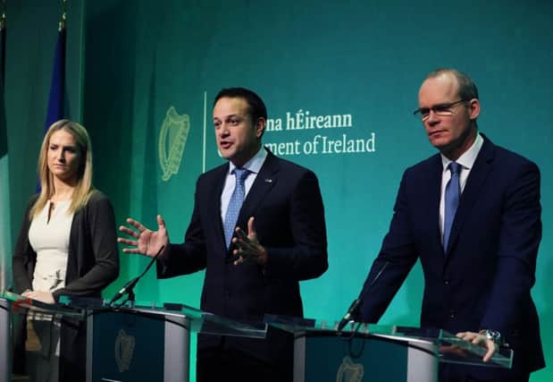 Taoiseach Leo Varadkar (centre), Tanaiste Simon Coveney (right) and Minister for European Affairs Helen McEntee speaking at the Government Press Centre in Dublin after the European Commission announced that "sufficient progress" has been made in the first phase of Brexit talks. Picture date: Friday December 8, 2017. See PA story POLITICS Brexit. Photo credit should read: Brian Lawless/PA Wire