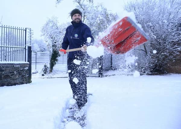 Patrick Morgan pictured shovelling snow in Belfast