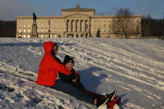 There have been long spells of sunshine in November and this month. Above, Natalie Trotter and her son Logan, 9, try sledding on the grounds of Stormont Estate, Belfast, yesterday.  Photo: Brian Lawless/PA Wire