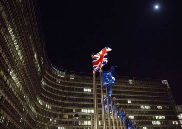 The British and EU flags flap in the wind outside EU headquarters in Brussels on Friday, Dec. 8, 2017. Photo: (AP Photo/Virginia Mayo)