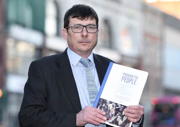 John Kennedy, a member of the expert advisory panel on adult care and support, with a copy of its report