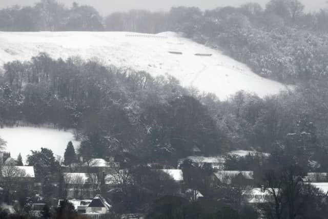 A snow covered hill and roof tops