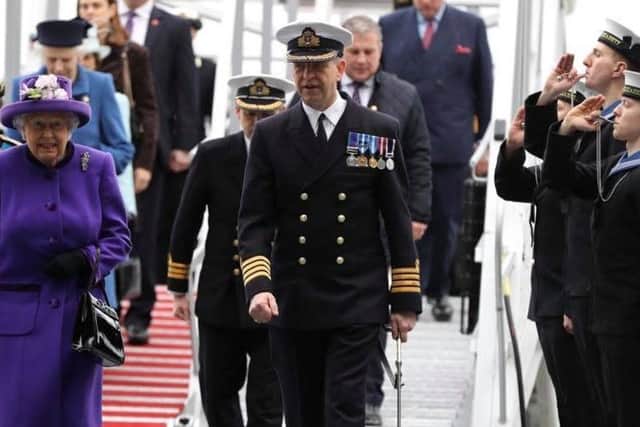 Philip Crozier (far right, middle) pipes Her Majesty The Queen aboard her namesake vessel during the ceremony. INCT 51-722-CON