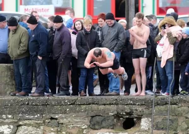 A scene from last year's Spina Bifida Hydrocephalus New Year's Day charity swim at Carnlough Harbour. INBT 01-108JC