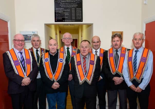 Members of Cookstown District pictured with the memorial plaque tribute to local Orangemen who were murdered during the Troubles