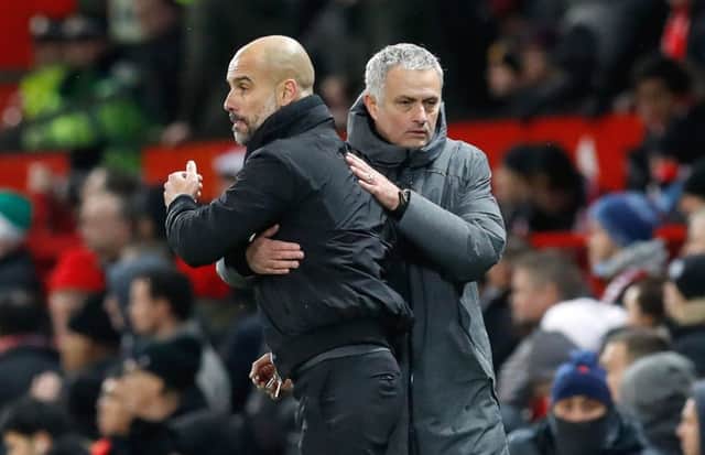 Pep Guardiola (left) and Jose Mourinho after the Manchester derby. Photo credit: Martin Rickett/PA Wire.