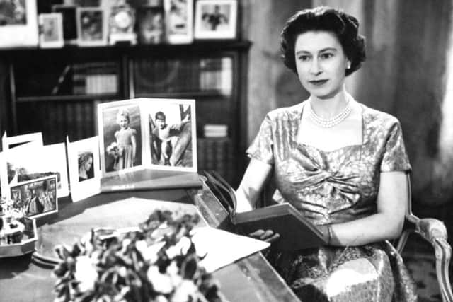 Queen Elizabeth II in a gold lame dress recording her Christmas Day message to the Commonwealth in the Long Library at Sandringham in 1957. PA