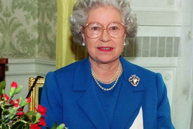 Queen Elizabeth II recording her Christmas Day message to the Commonwealth at Buckingham Palace in 1999. PA