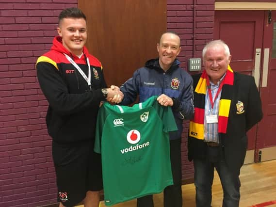 Jacob Stockdale presents one of his Ireland shirts to Lurgan Junior High School during a visit