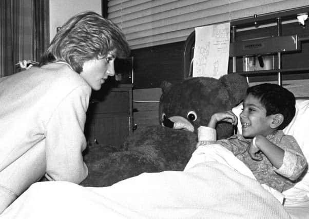 The Princess of Wales chats to a young victim of the 1983 Harrods car bomb
