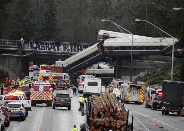 An Amtrak train making an inaugural run on a new route derailed south of Seattle on Monday, spilling train cars onto a busy interstate in an accident that resulted in "multiple fatalities" and numerous injuries, authorities said.  (AP Photo/Rachel La Corte)