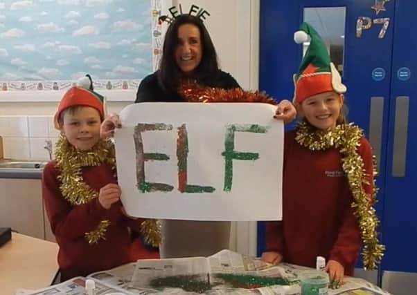 Teacher Mrs McKnight with two of the pupils who star in Pond Park Primary School's Christmas video.