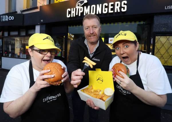 Michael Ferris (centre) owner of Chipmongers Lisburn pictured with staff members, Kim Irvine (left) and Caroline Alexander, sampling some of the fantastic fayre available at Chipmongers