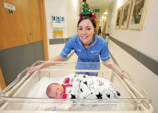 December 25, 2017: 

Midwife Sarah Magowan with the daughter of Anna Urbanska from Lisburn at the Ulster Hospital in Dundonald, Belfast . The baby was born at  00.49am. Ms  Urbanska had not named her baby at time it was taken.