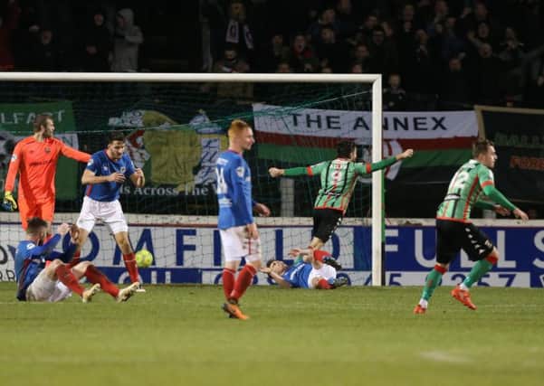 Glentoran's Robbie McDaid's shot is deflected in off a Linfield player for the winning goal