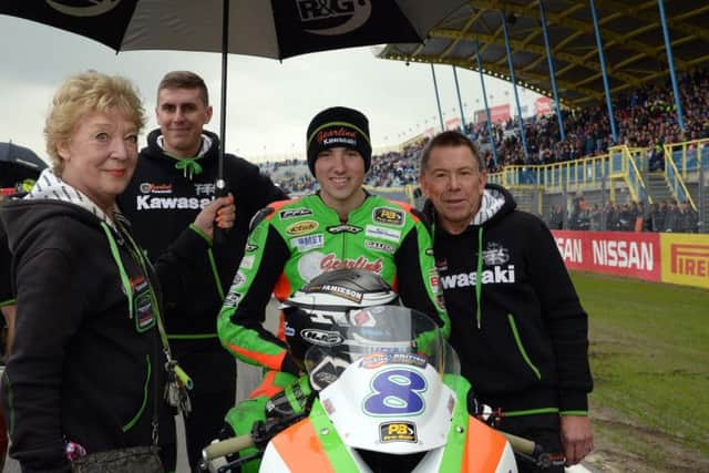 Andrew Irwin pictured on the grid with Gearlink Kawasaki team owners Norma and Michael de Bidaph.