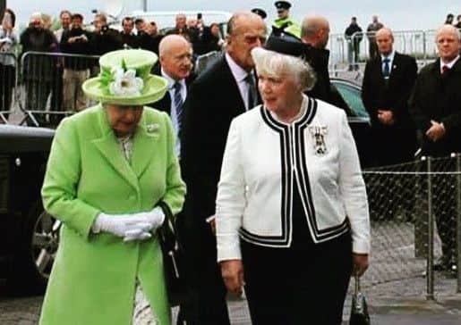 Joan Christie having a chat with the Queen who has awarded her a Commander of the Victorian Order