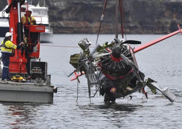The wreckage of the plane is removed from the Hawkesbury River on Thursday