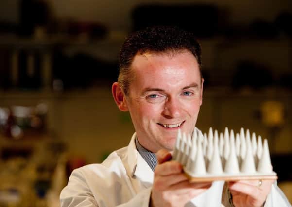Professor Ryan Donnelly holding a magnified prototype of microneedles, as researchers have said that a new skin patch could save many lives and tackle the antibiotic resistance crisis.  Photo: Queen's University Belfast/PA Wire