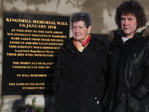 Beatrice Worton (left), mother of Kingsmill victim Kenneth Worton, and his daughter Racquel Brush, attend a roadside service marking the 42nd anniversary of the shooting dead of 10 Protestant workmen by republicans at Kingsmill in South Armagh