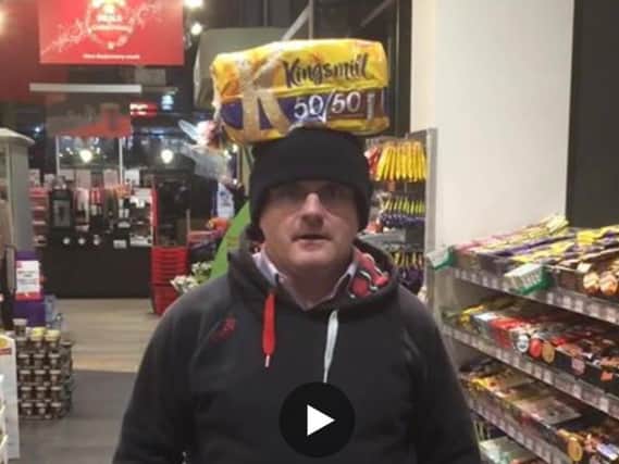 Sinn Fein MP Barry McElduff with the Kingsmill-branded loaf on his head
