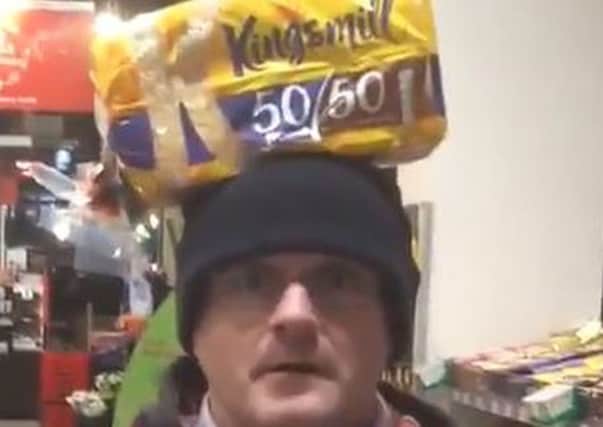 Barry McElduff with a Kingsmill-branded loaf on his head on the anniversary of the Kingsmill massacre.