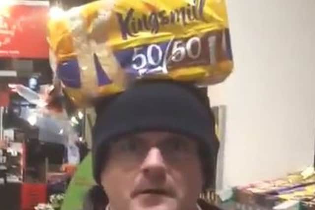 Barry McElduff with a Kingsmill-branded loaf on his head on the anniversary of the Kingsmill massacre.