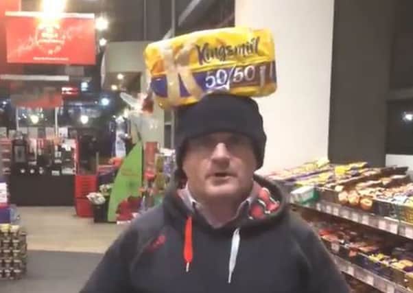 A video grab taken from the Twitter feed of Sinn Fein MP Barry McElduff showing him with a Kingsmill-branded loaf on his head on the anniversary of the Kingsmill massacre.