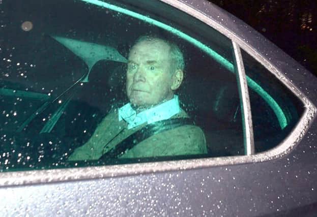 Martin McGuinness being driven away from Stormont on the night he resigned a year ago