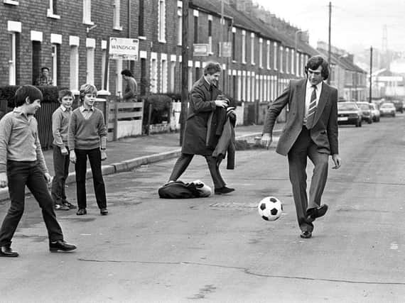 1984: NI goalkeeping legend Pat Jennings has a 'kickabout' with kids in the streets beside Windsor Park